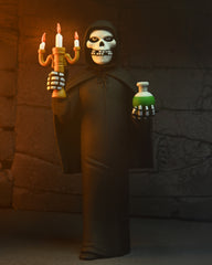 Skeleton fiend figure in black robe with candelabra and green bottle, blister card packaging