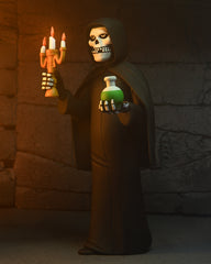 Skeleton Fiend Figure in dark robe, holding candle and potion, with blister card packaging
