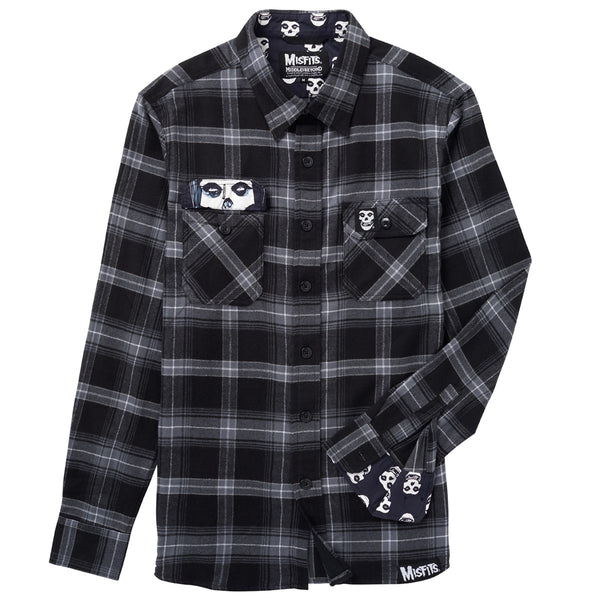 Black and gray plaid long sleeve flannel shirt with skull designs on pockets and cuffs