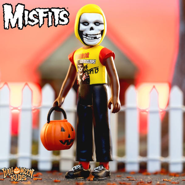 Action figure of Misfits Halloween Kids character with pumpkin bucket in yellow shirt