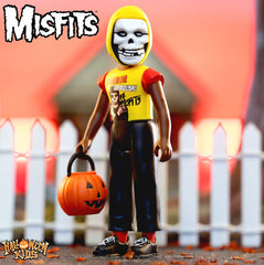 Action figure of Misfits Halloween Kids character with pumpkin bucket in yellow shirt